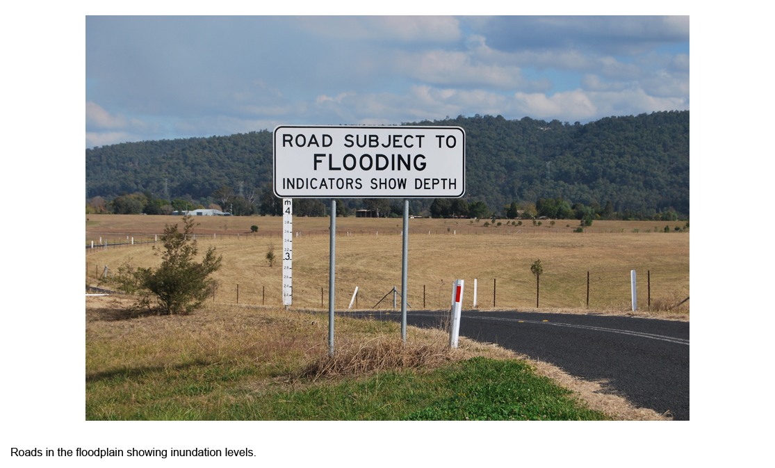 Roads in the floodplain showing inundation levels sign