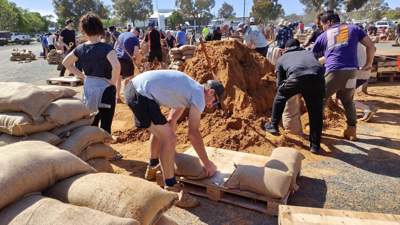 Community members putting sandbags together