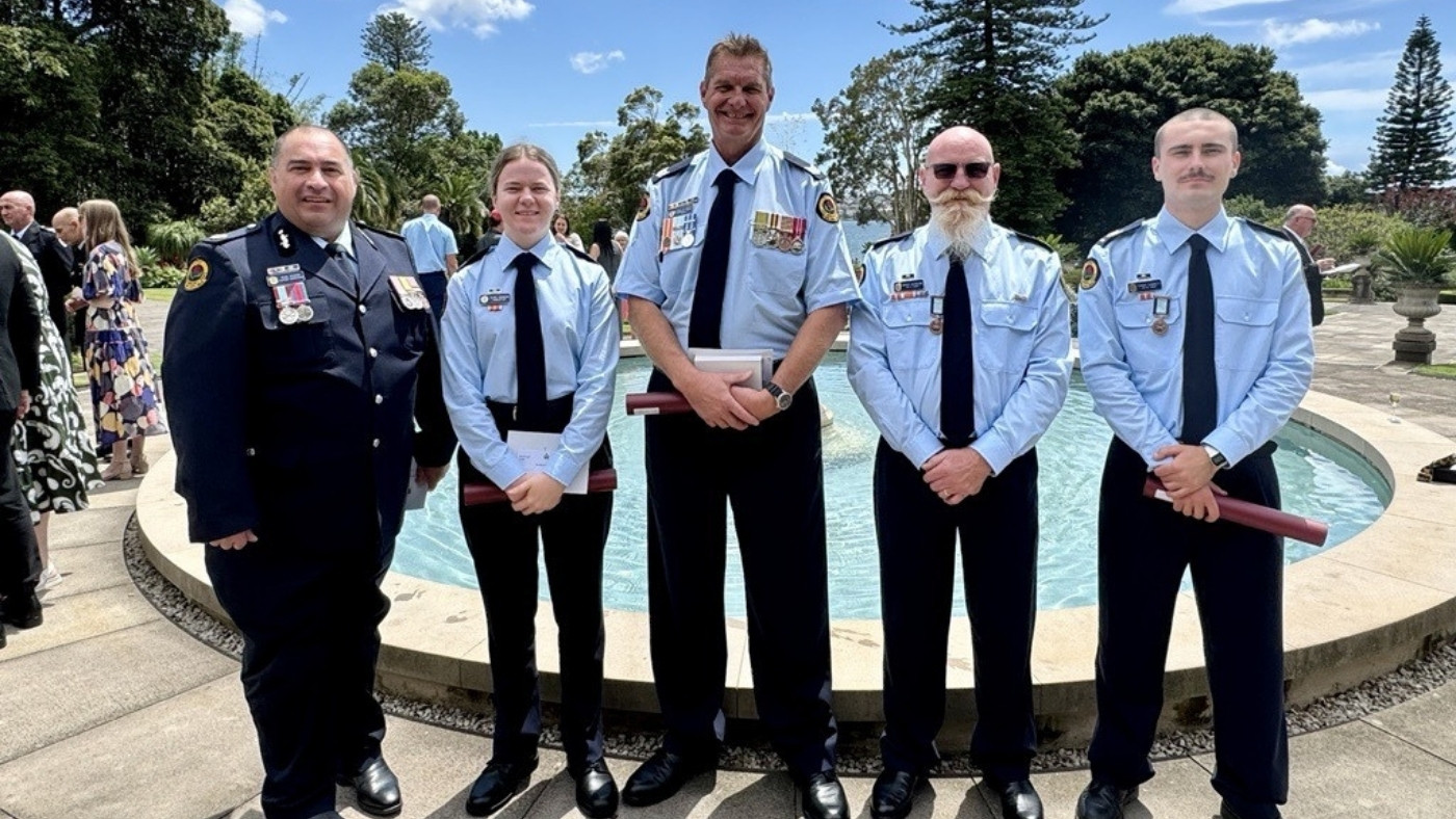 Fiver NSW SES members standing alongside each other after receiving bravery awards