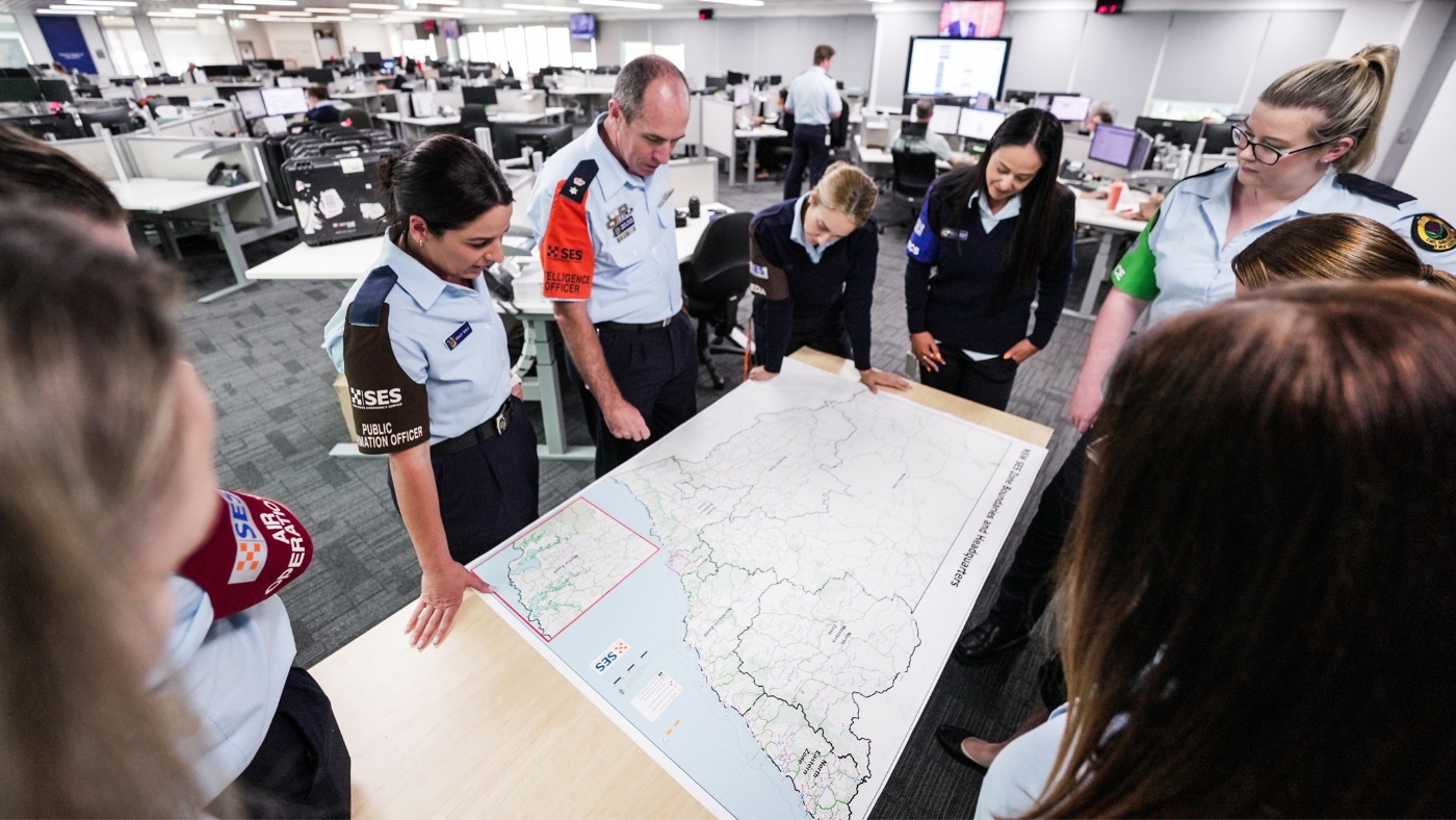 Incident Management Team gathered around a table and looking at a map