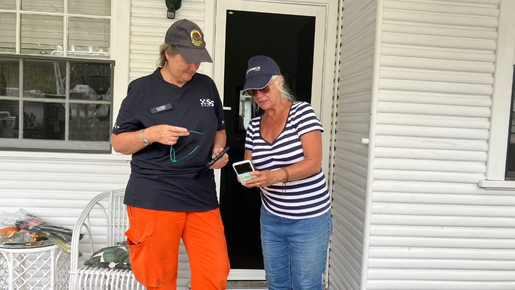 Member showing resident to download Hazards Near Me app.