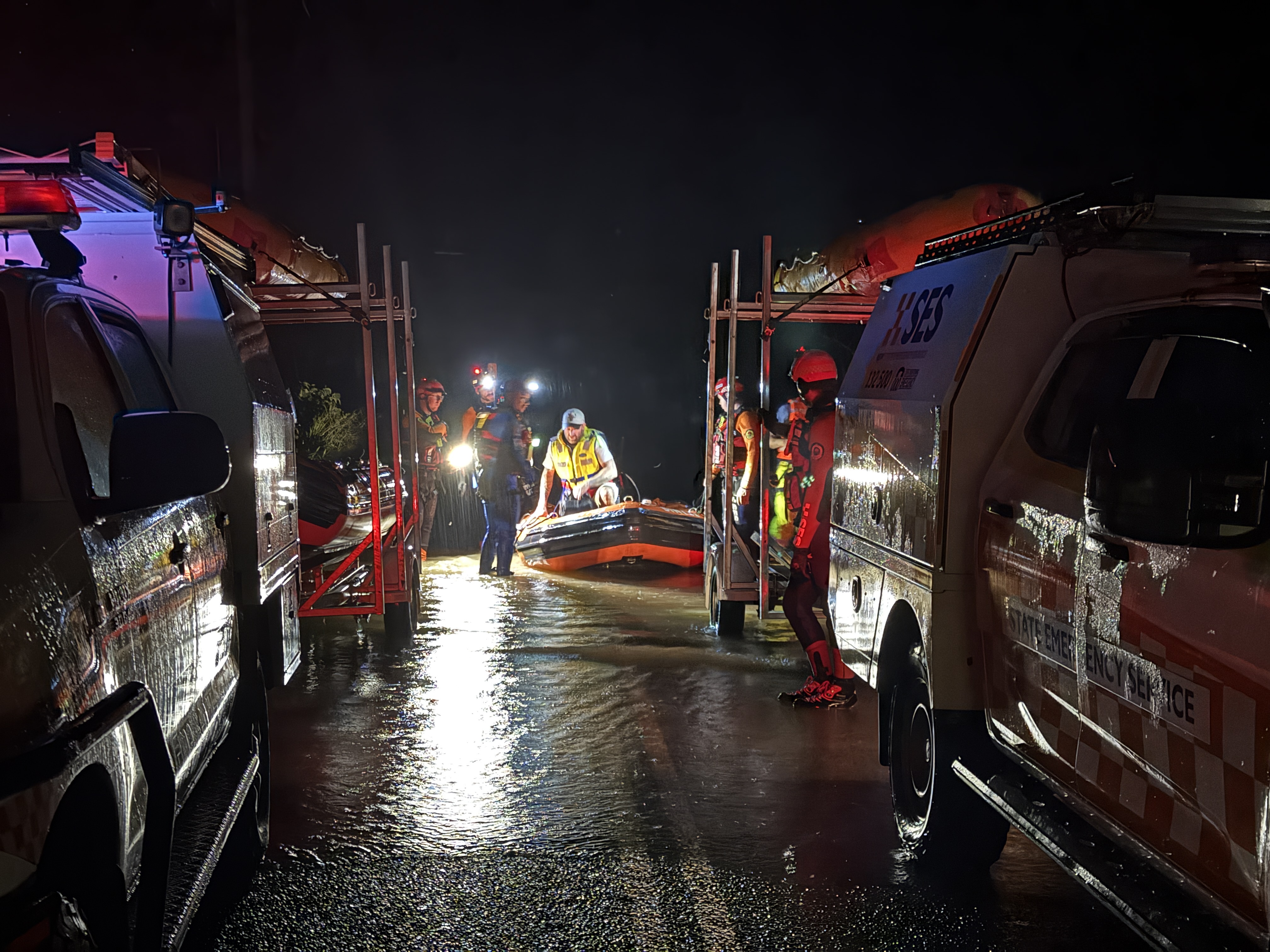 Flood rescue with vehicles on either side on dry land